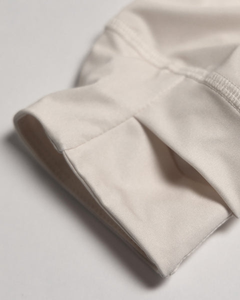 A close-up of the Sunteez Hoodie in Bone, made in the USA, showcasing detailed stitching and smooth white fabric texture, possibly highlighting a sleeve or cuff, set against a neutral background.