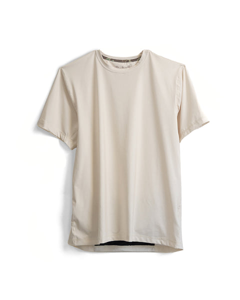The Sunteez Short Sleeve in Bone, made from moisture-wicking performance stretch fabric, hangs against a white background.