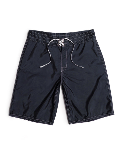 Navy 312 Boardshorts with white stitching and a white drawstring, made in the USA and laid flat on a white background. These long-length boardshorts offer timeless style and durability.