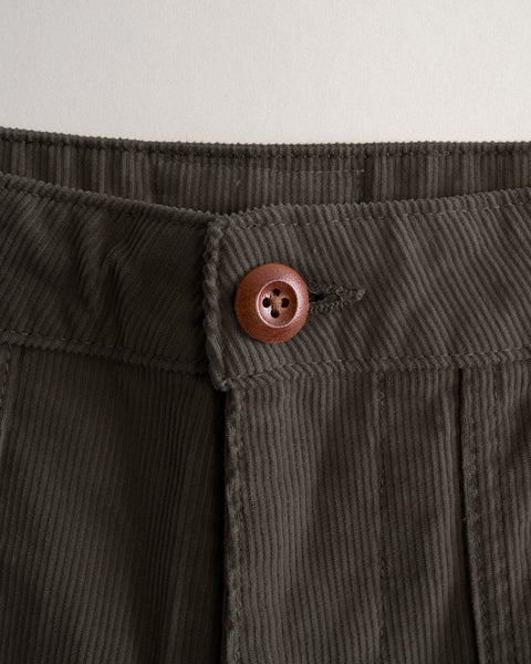 Close-up of brown Classic Corduroy Pants in 100% cotton, featuring a wooden button at the waistband.