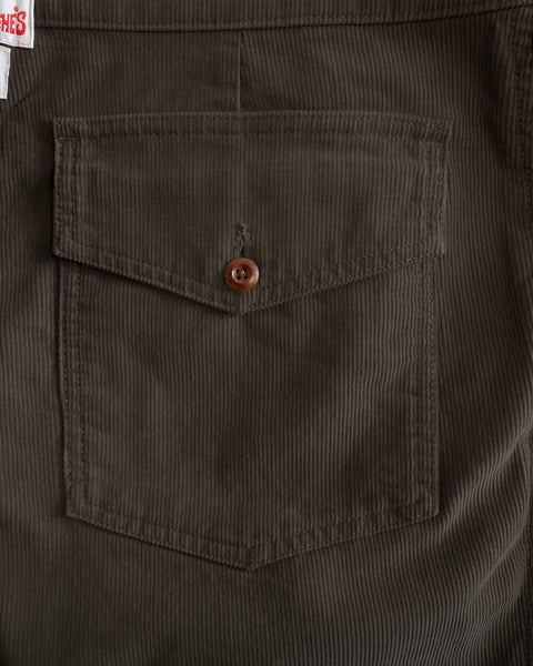 Close-up of a brown corduroy pocket with a button closure on Classic Corduroy Pants - Brown.
