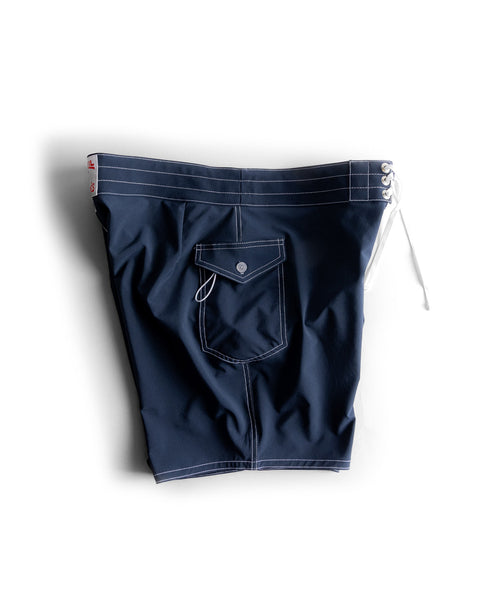 808 SurfStretch Side Pocket Boardshorts - Navy, featuring white contrast stitching, a button-flap side pocket, and a lace-up front closure.