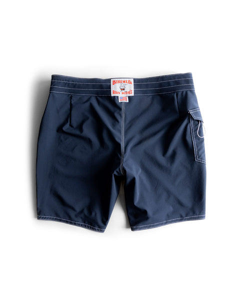 Navy 808 SurfStretch Side Pocket Boardshorts with white contrast stitching, a rear patch pocket with a white drawstring loop, and a brand label on the center back waistband.
