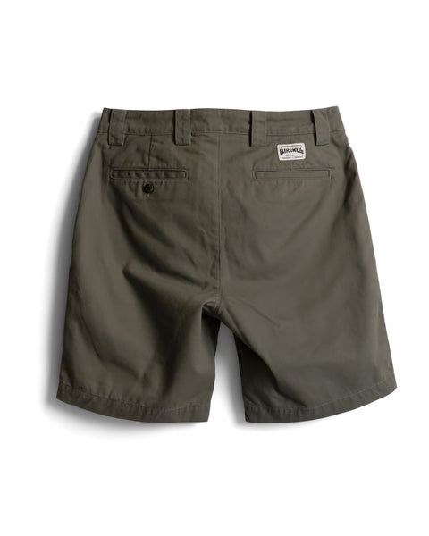 Back view of Stockman Chino Shorts - Moss in olive green cotton twill, featuring a buttoned welt pocket and a branded patch on the back waistband.