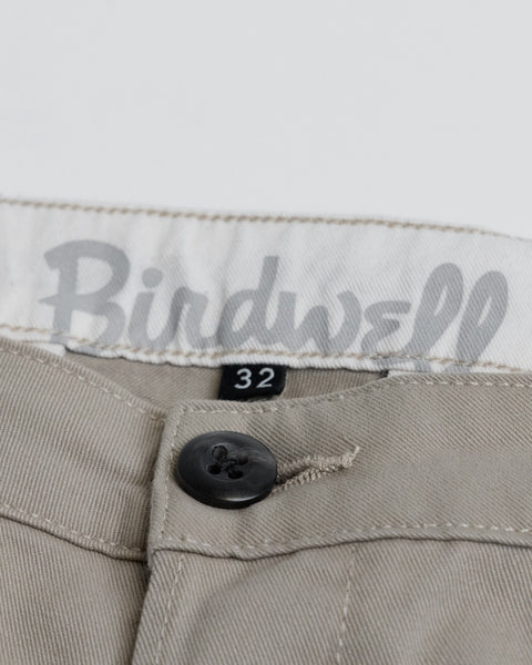 Close-up of the waistband and button of light beige Stockman Chino Shorts - Bone, showing a size 32 tag.