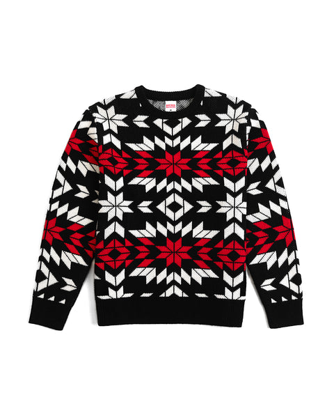 Christmas Sweater on white background with geometric holiday pattern in red, white and black.