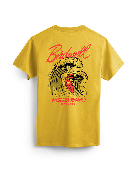 Back of gold t-shirt featuring a graphic of birdie mascot surfing on a wave in red and black. Text featuring “Birdwell” and “California Originals Since 1961.”