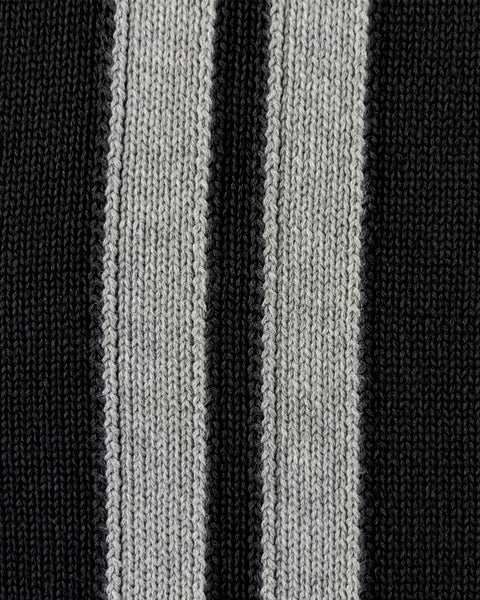 Close-up of gray stripes on the black sweater.