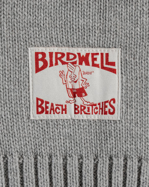 Close-up of a label with 'Birdwell Beach Britches' text and logo on a woven sweater.