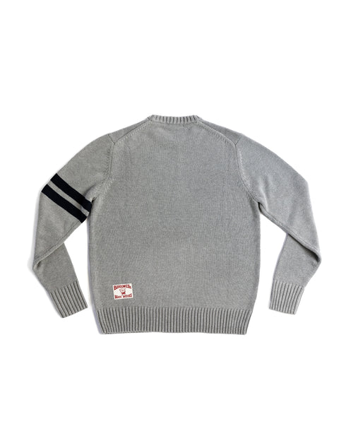 Back View of the Comp Stripe Sweater in Grey with two bone stripes on the left arm. Product on white background. License plate label on bottom left corner.