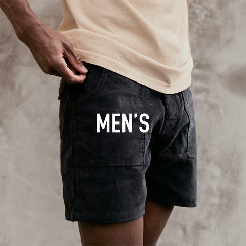 Image of Obi wearing the Classic Corduroy Shorts in Charcoal with a tan shirt.