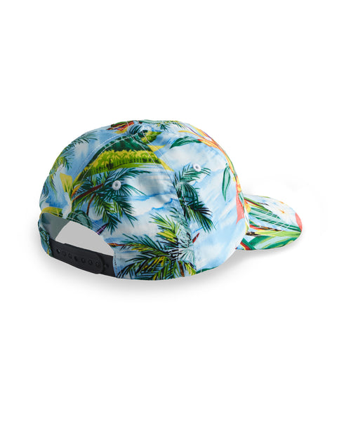 Image shows back view Paradise Snapback. Pattern depicts tropical foliage and blue sky. 