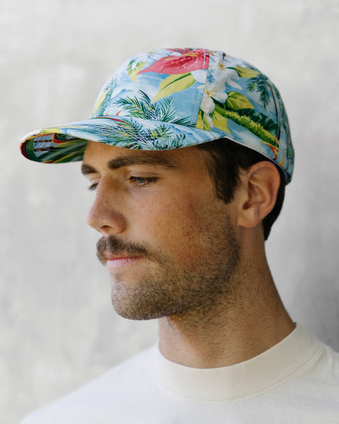 Model wears Paradise Snapback in front of grey background.