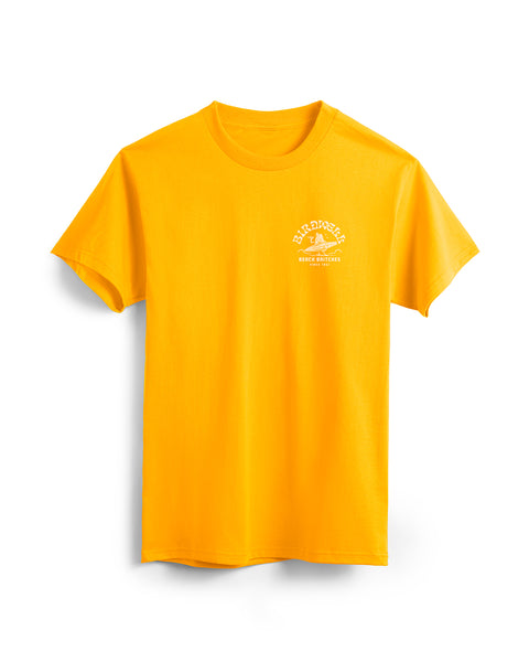 Front of Gold T-Shirt with Surfin' Birdie Graphic on left Side Featuring Birdie Holding a Surfboard. Text on shirt says Birdwell Beach Britches Since 1961