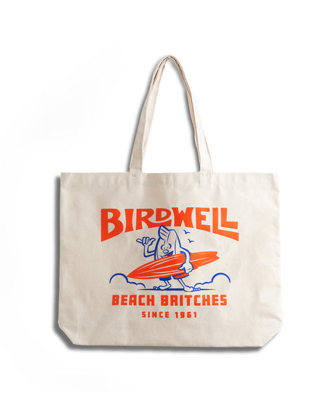 Front view of the Surfin' Birdie tote. Orange and blue graphic shows Birdie with a surfboard with text reading 'Birdwell Beach Britches Since 1961'.