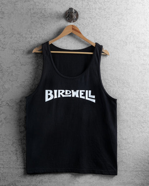 Image shows the front view of the Wordmark tank in black hanging on a wooden hanger with concrete background.